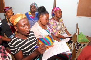Kasoa Market Women filling a research questionaire during the townhall meeting